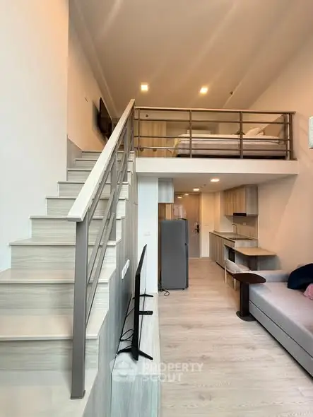 Modern loft apartment with mezzanine bedroom and stylish open-plan living area.