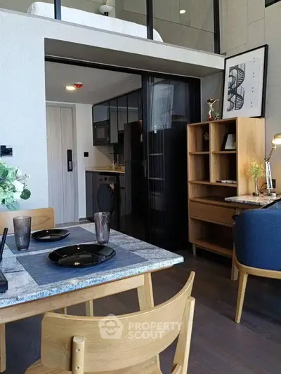 Modern loft apartment with stylish dining area and compact kitchen