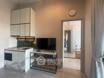 Modern studio apartment with sleek kitchen and cozy living area, perfect for urban living.
