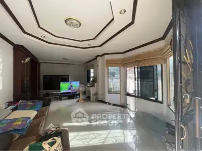 Spacious living room with modern decor and large windows for natural light.