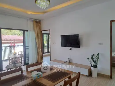 Spacious living room with modern decor and balcony access in a stylish home.