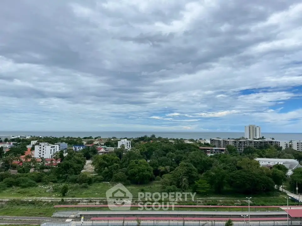Stunning panoramic view of lush greenery and cityscape under a vast sky, perfect for serene living.