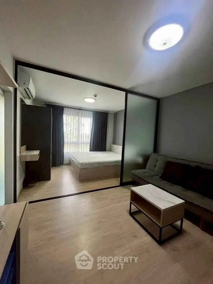 Modern studio apartment with glass partition and cozy furnishings