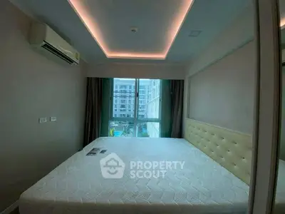 Modern bedroom with large window and stylish ceiling lighting in urban apartment.