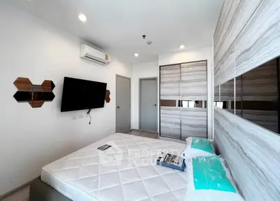 Modern bedroom with stylish decor and built-in wardrobe in a contemporary apartment.