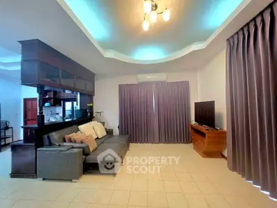Spacious living room with modern decor and open kitchen layout, perfect for entertaining.