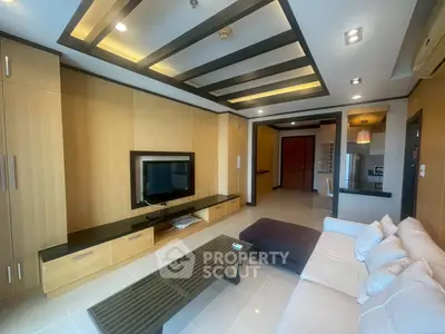 Modern living room with sleek design, built-in TV unit, and cozy seating area in a stylish apartment.