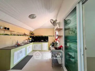 Spacious kitchen with modern design and ample storage in a bright, airy home.