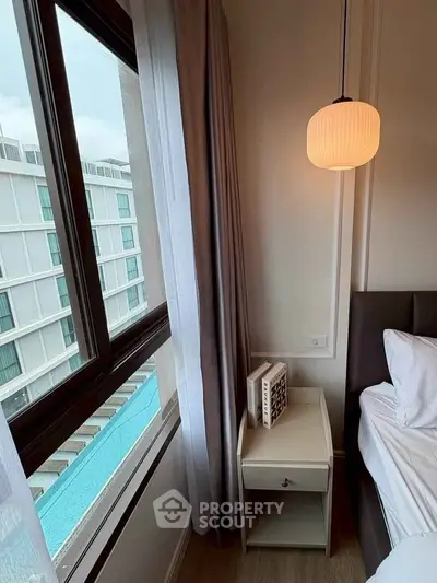 Modern bedroom with pool view, stylish lighting, and elegant decor for a serene living experience.