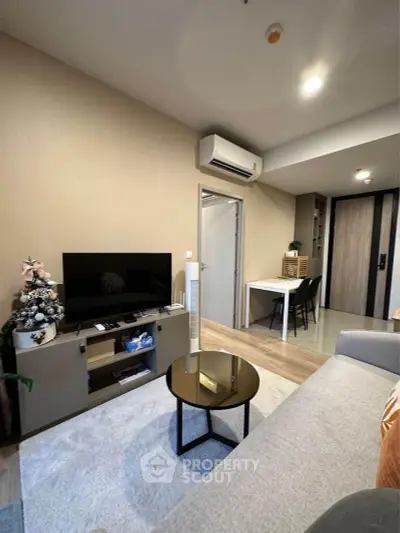 Modern living room with sleek furniture and air conditioning, perfect for cozy urban living.