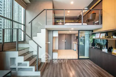 Modern loft apartment with mezzanine bedroom and stylish open-plan living area, featuring floor-to-ceiling windows.