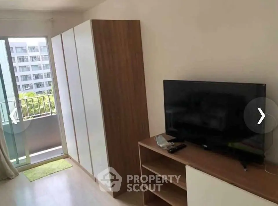 Modern living room with balcony view and sleek furniture in urban apartment