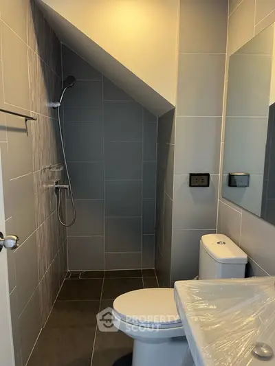 Modern bathroom with sleek design and sloped ceiling