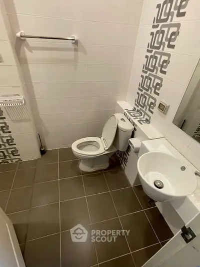 Modern bathroom with stylish tile design and compact fixtures, perfect for urban living.