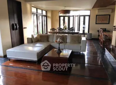 Spacious living room with elegant wooden flooring and modern furniture