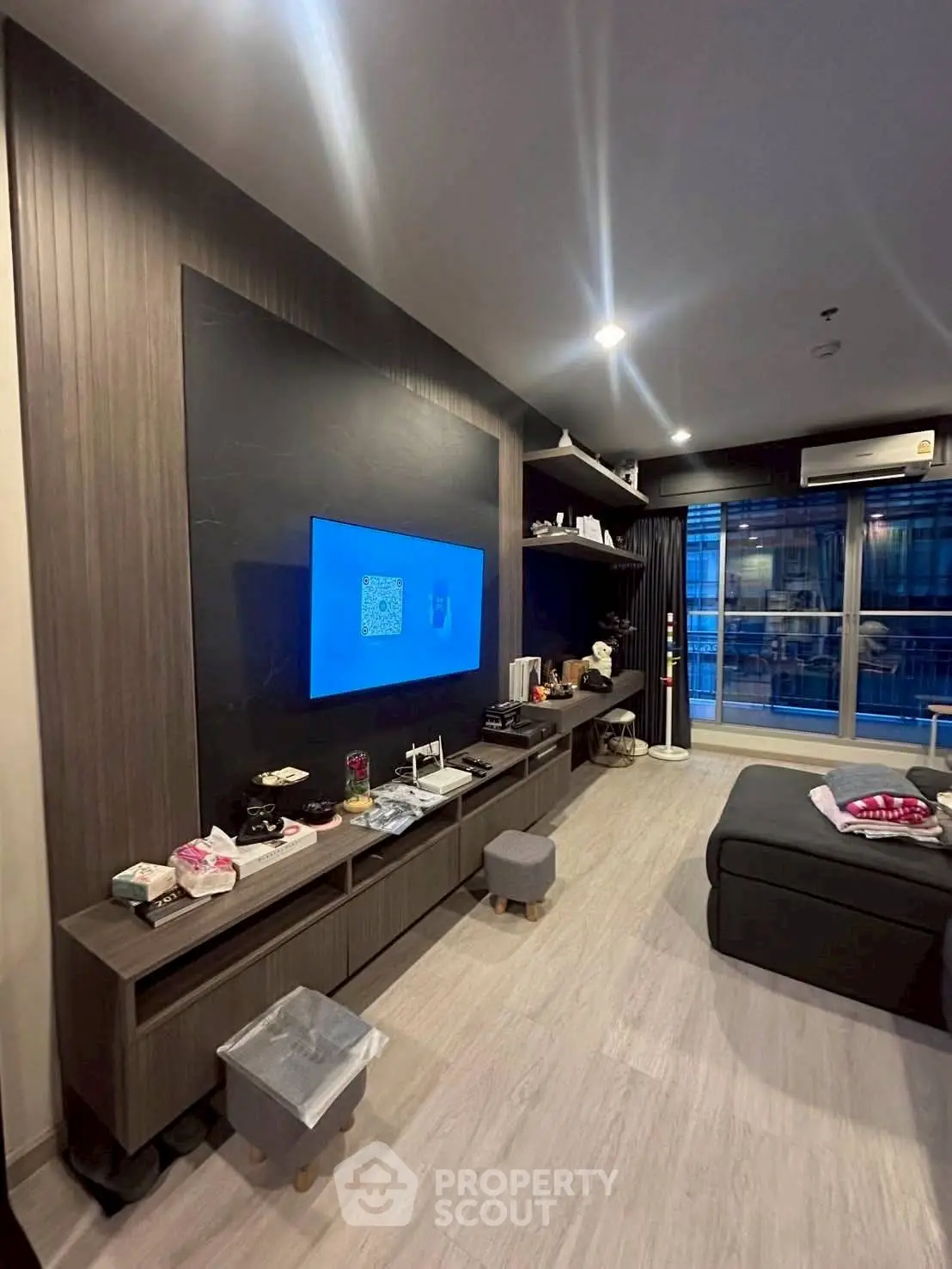 Modern living room with sleek entertainment center and cozy seating area