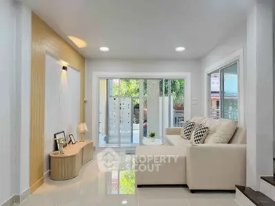 Modern living room with sleek design and large windows for natural light.