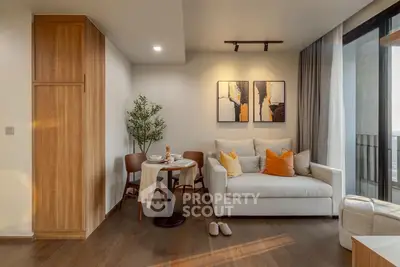 Modern living room with cozy sofa, dining area, and stylish decor in a bright apartment.