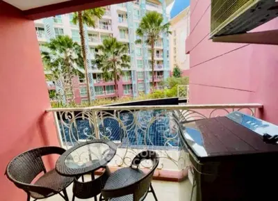 Charming balcony with pool view in vibrant apartment complex.