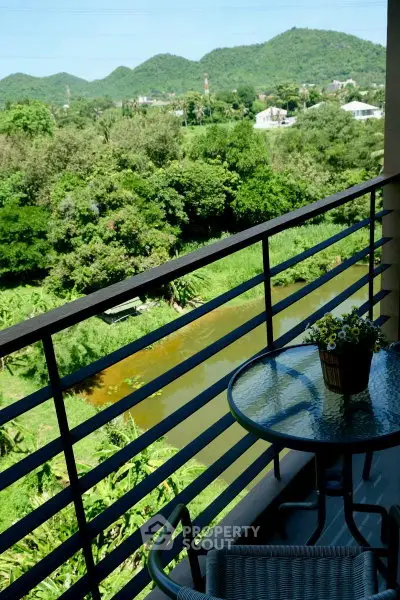 Charming balcony with scenic mountain and river view, perfect for relaxation.
