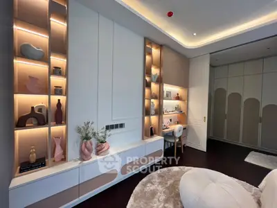 Luxurious modern living room with elegant built-in shelves and cozy seating area.