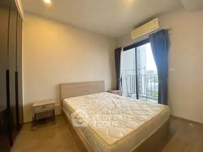 Modern bedroom with balcony view and air conditioning in urban apartment.
