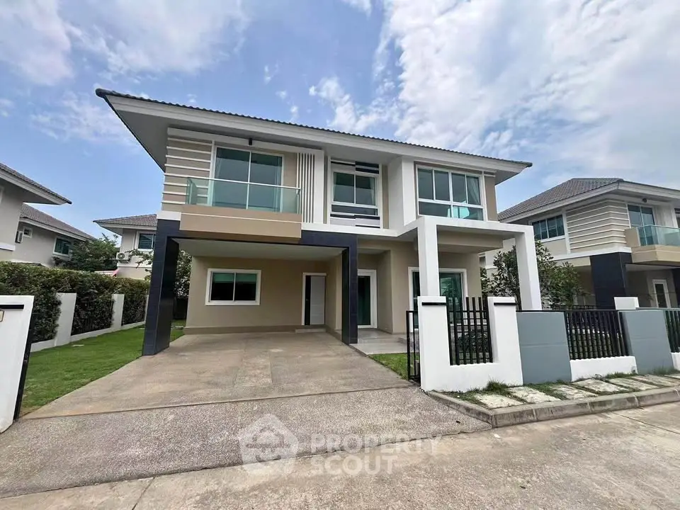 Modern two-story house with spacious driveway and contemporary design in a suburban neighborhood.