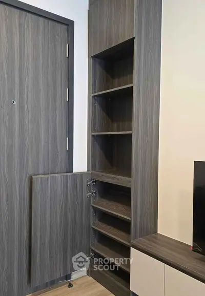 Modern interior with sleek wooden storage shelves and door, perfect for maximizing space in a stylish home.