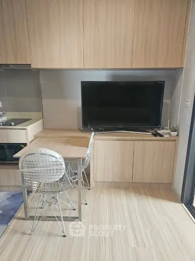 Modern kitchen with sleek cabinetry and built-in appliances in a compact space.