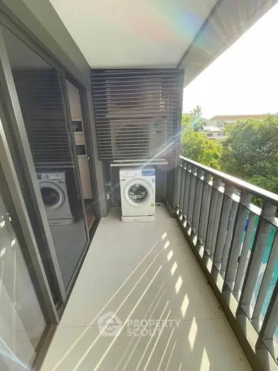 Modern balcony with washing machine and sleek railing design
