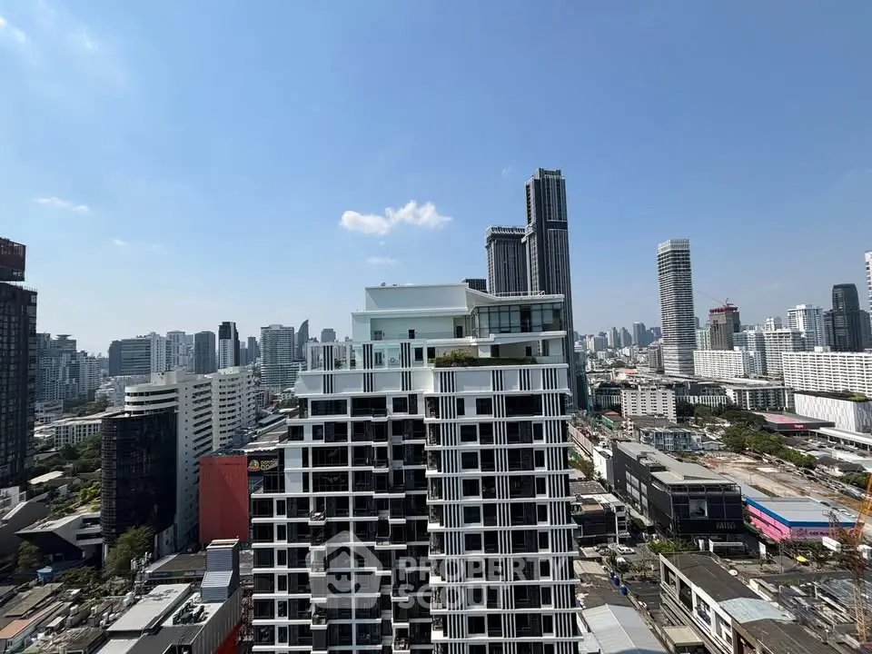 Stunning cityscape view showcasing modern high-rise buildings under a clear blue sky.