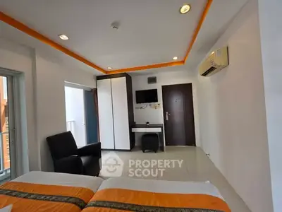 Modern bedroom with sleek design, featuring air conditioning and stylish furniture.