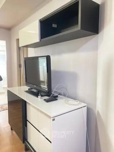 Modern living room with sleek TV stand and wall-mounted cabinet