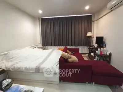 Cozy bedroom with red sofa and modern decor