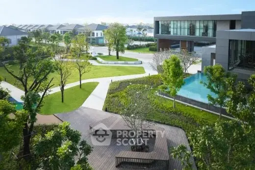 Luxurious modern residential complex with lush greenery and pool view