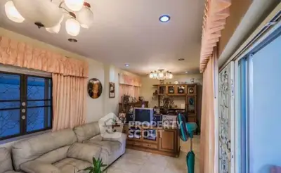 Spacious living room with cozy seating and elegant lighting, perfect for relaxation and entertainment.