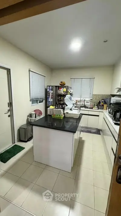 Modern kitchen with sleek countertops and stainless steel appliances in a cozy home setting.