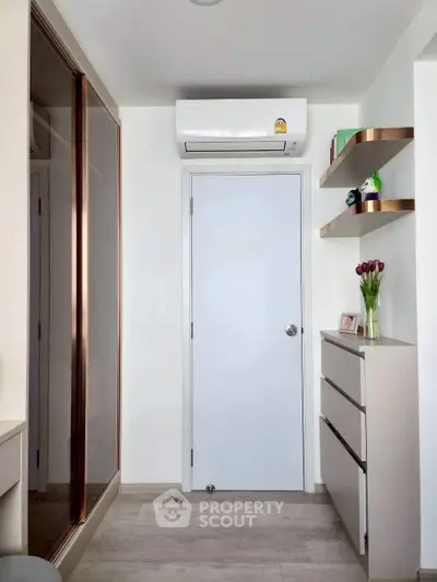 Modern bedroom with sleek storage and air conditioning unit