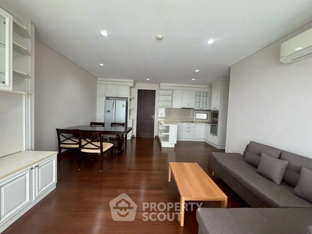 Spacious modern living room with open kitchen and elegant wooden flooring