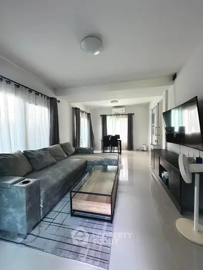 Spacious modern living room with large sofa and sleek decor
