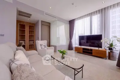 Spacious modern living room with large windows and elegant decor