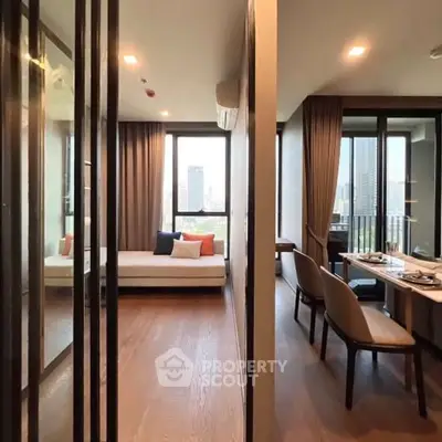 Modern living room with city view, elegant decor, and cozy seating area.