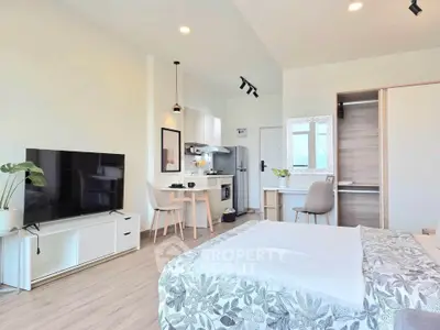 Modern studio apartment with open layout, featuring a cozy living area, dining space, and stylish kitchen.
