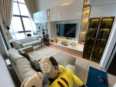 Luxurious living room with plush sofa, large TV, and elegant decor