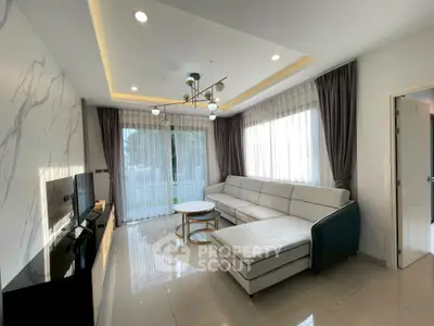 Modern living room with elegant lighting and large windows