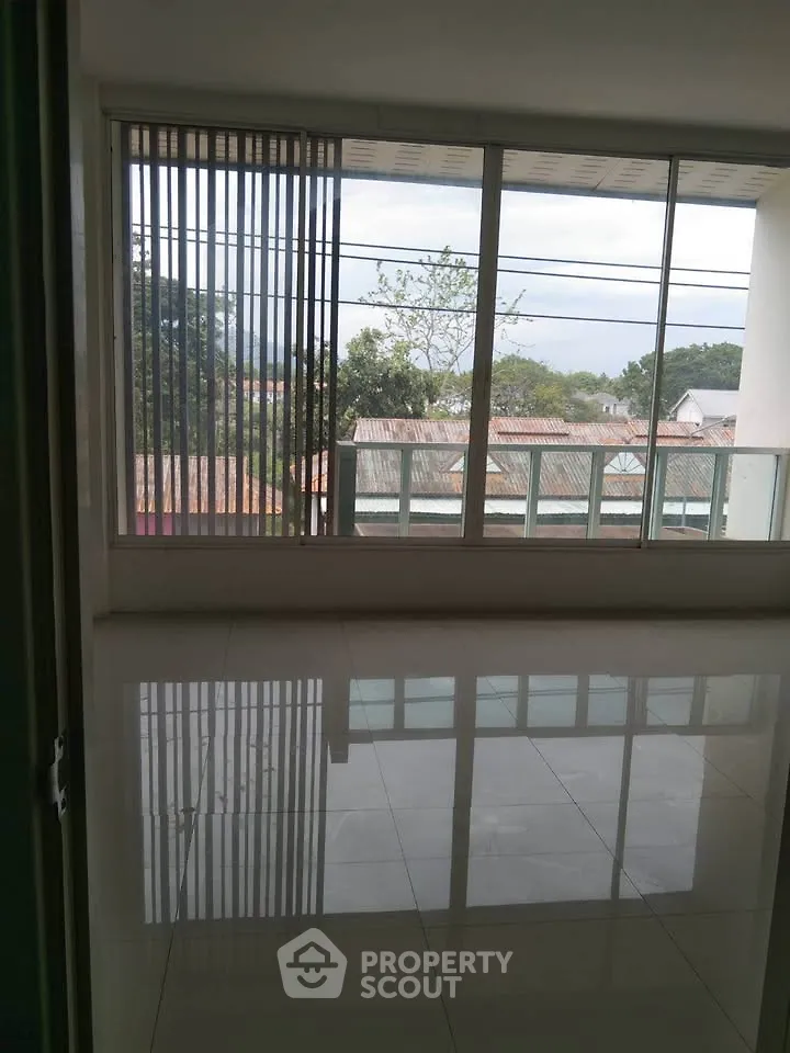 Spacious living room with large windows offering a scenic view, perfect for natural light lovers.