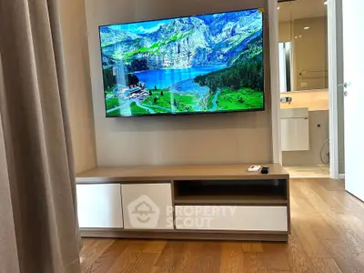 Modern living room with wall-mounted TV and sleek wooden flooring