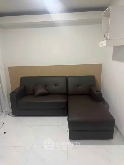 Modern living room with sleek dark sofa and minimalist decor