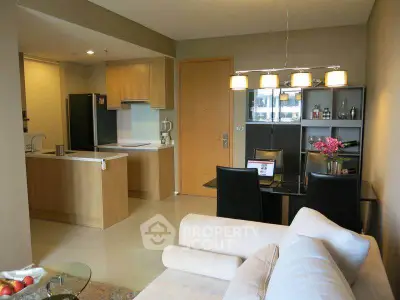 Modern open-plan living room and kitchen with stylish dining area and cozy seating.