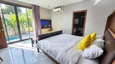 Modern bedroom with pool view and stylish decor in luxury home